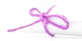 Handmade pink cord node tied on white message scroll isolated Royalty Free Stock Photo