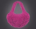 Handmade pink string bag on grey background. Close-up. Raffia bag.