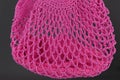 Handmade pink string bag on grey background. Close-up. Raffia bag. Royalty Free Stock Photo