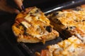 A Handmade Pizza Pie Was Cut Using A Knife By A Woman. Closeup Food Picture