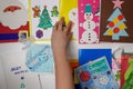 Handmade postcards and photos of children from the shelter are laid out in a circle. Charity. New Year and Christmas concept. The