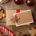 Handmade present box with tags on vintage wooden background, christmas decor closeup, copy space. Royalty Free Stock Photo