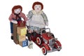 Toy cloth dolls, raggedy Ann, Andy stand by blocks, fire engine, hat, dog ready for playtime with vintage toys.