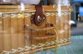 Handmade rectangular honey rattan wicker storage vintage basket on window display.