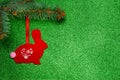 Handmade red Christmas tree toy made of felt in the form of a rabbit with applique Royalty Free Stock Photo