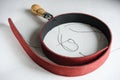 Handmade Red Leather Belt sewing with awl at table Royalty Free Stock Photo