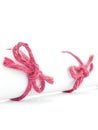 Handmade red rope bows tied on white message scroll isolated Royalty Free Stock Photo