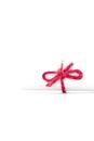 Handmade red string node tied on white paper scroll isolated Royalty Free Stock Photo