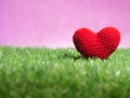 Handmade red yarn heart on Green grass background is royal pink.Copy space for text, Valentines day, love concept Royalty Free Stock Photo