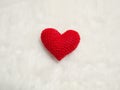 Handmade red yarn heart on white wool. the red heart on the center of picture and background copy space for text. Valentines day,