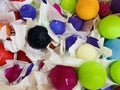 Handmade round candles in bright colors in a paper wrapper