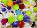 Handmade round candles in bright colors in a paper wrapper