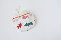 Handmade round pouch with dogs, hair pins and lip balm over white