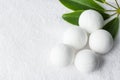 Handmade salt bath bombs in balls shape from organic vegan natural ingredients on white towel green house plants. Spa wellness