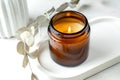Handmade scented candle in a glass on a concrete tray. Soy wax candles with a wooden wick. Close up Royalty Free Stock Photo