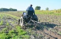 Handmade small tractor plowing field. Old tractor plowing on the farmland