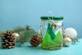 Handmade snow globe and Christmas decorations on light blue background Royalty Free Stock Photo