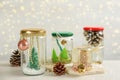 Handmade snow globes and fir cones on light table Royalty Free Stock Photo