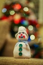 Handmade snowman made from a sock filled with rice and decorated with buttons