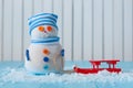Handmade snowman stay with red sled on light Royalty Free Stock Photo