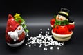 Handmade snowmen figurines isolated on black background. Christmas decoration.