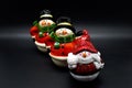 Handmade snowmen figurines isolated on black background. Christmas decoration.