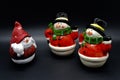 Handmade snowmen figurines isolated on black background. Christmas decoration.