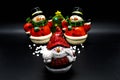 Handmade snowmen figurines isolated on black background. Christmas decoration.