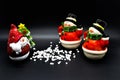 Handmade snowmen figurines isolated on black background. Christmas decoration.