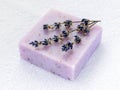 Handmade soap bar with dry aromatic lavender flowers. Purple  soap on a white terry cotton towel. Natural toiletries and hygiene Royalty Free Stock Photo