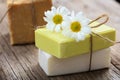 Handmade soap bars and chamomile on wooden background Royalty Free Stock Photo