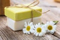 Handmade soap bars and chamomile on wooden background Royalty Free Stock Photo