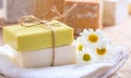 Handmade soap bars and chamomile on wooden background Royalty Free Stock Photo