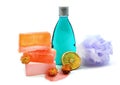 Handmade soap, blue colored shower gel bottle and soft bath puff or sponge.