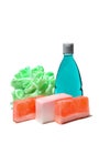 Handmade soap, blue colored shower gel bottle and soft green bath puff or sponge.
