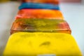 Many colorful soap pieces lying in a line on the white table Royalty Free Stock Photo