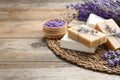 Handmade soap with lavender flowers on brown wooden table. Space for text