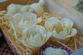 Handmade soaps in form of flowers in wooden box Royalty Free Stock Photo