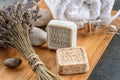 Handmade soaps with lavender bunch and stones on wooden board, product of cosmetics or body care