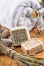 Handmade soaps with lavender bunch and stones on wooden board, product of cosmetics or body care Royalty Free Stock Photo