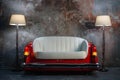 A handmade sofa and a lamp on a grunge style wall background. Made to order from the car seat. Royalty Free Stock Photo