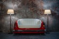 A handmade sofa and a lamp on a grunge style wall background. Made to order from the car seat. Royalty Free Stock Photo