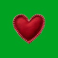 Handmade felt heart isolated on green background Royalty Free Stock Photo