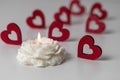 Handmade soy wax candle in flower shape and red hearts on white background. Valentine's day, romance, love concept Royalty Free Stock Photo