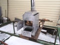 Handmade stainless steel wood stove with open ash pit and oven door