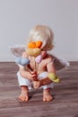 Handmade textile hearts in the hands of little Cupid