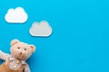 Handmade toys for newborn baby. Teddy bear. Blue background top view mockup