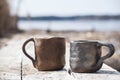 Handmade two cups with folk signs of black pottery from clay Royalty Free Stock Photo