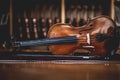 handmade viola leaning sideways with a row of violins on the background at a musical instrument store Royalty Free Stock Photo