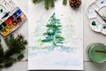 Handmade watercolor Christmas card on the work table